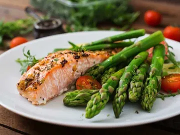 A plate of food with asparagus and salmon.