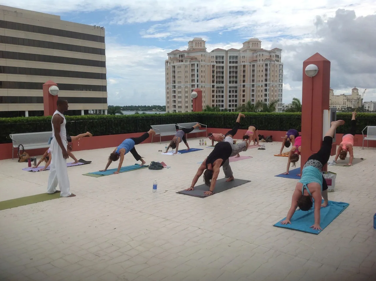 A group of people doing yoga on the roof.
