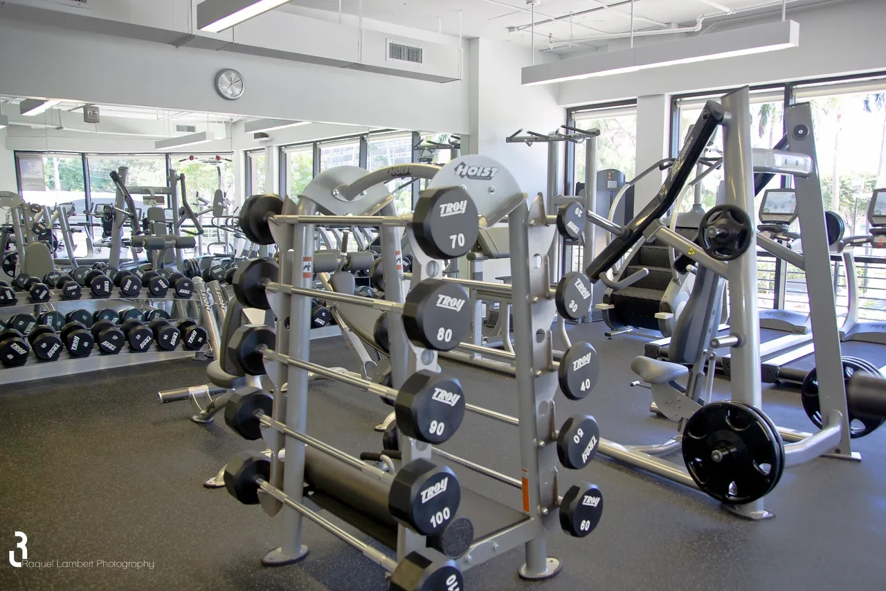 A gym with many different types of exercise equipment.